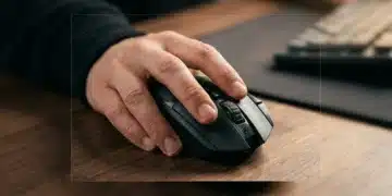 Close-up of hands interacting with an ergonomic gaming mouse, highlighting subtle design elements and texture under warm, diffused light.